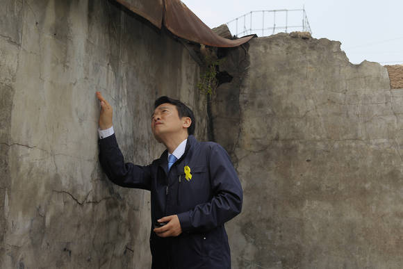 21일 남경필 새누리당 경기도지사 후보가 성남 중앙시장을 방문해 건물의 균열을 바라보며 심각한 표정에 빠져있다.(사진=남경필 경기도지사 후보 선거사무소 제공)