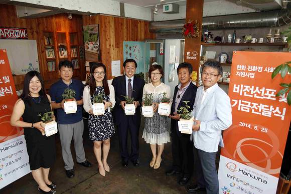 25일 서울 마포구 동교동의 한 카페에서 올해 지원대상으로 선정된 기업의 대표들이 친환경 사회적기업을 상징하는 화분을 들고 힘찬 도약을 다짐하고 있다(사진 제공: 한화그룹)