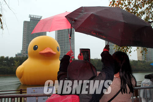 21일 오후 서울 송파구 석촌호수에 떠 있는 러버덕을 보기위해 관람객들이 몰려 있다.(사진=왕진오 기자)