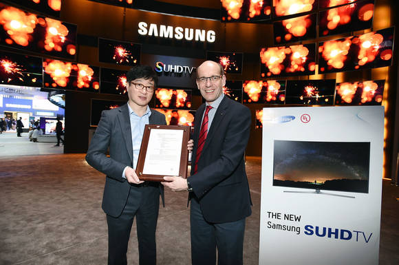 6일 미국 라스베이거스 ‘CES 2015’ 삼성전자 전시장 입구에서 ‘UL’과 함께 성능 인증 수여식을 갖은 모습. 왼쪽은 삼성전자 영상디스플레이사업부 유준영 상무, 오른쪽은 UL 컨슈머 테크놀로지 인증 사업부 부사장 스티븐 컬크(사진 제공: 삼성전자)