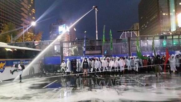 지난달 14일 민주노총 등 노동·농민·시민사회단체로 이뤄진 ‘민중총궐기 투쟁본부’가 개최한 ‘민중총궐기 투쟁대회’ 참가자들이 행진하던 중 경찰과 대치하면서 밤늦게까지 충돌을 빚었다. 경찰이 경찰버스를 발로 차고 있는 시위자를 향해 최루액을 섞은 물대포로 조준 사격하고 있다. (사진=CNB포토뱅크)